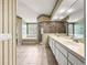 Bright bathroom with step-up tub, tiled floors, and walk-in shower at 28 Golf View Dr, Ocala, FL 34472