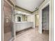 Bathroom featuring a glass shower, double sinks, and neutral finishes at 28 Golf View Dr, Ocala, FL 34472