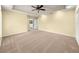 Large carpeted bedroom with tray ceiling and adjoining bathroom at 28 Golf View Dr, Ocala, FL 34472