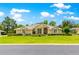 Beautiful single-story home with manicured lawn, lush landscaping, and a welcoming facade at 28 Golf View Dr, Ocala, FL 34472