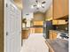 Spacious kitchen featuring tile floors, wood cabinets, modern appliances, and ample counter space for cooking at 28 Golf View Dr, Ocala, FL 34472