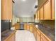 Efficient kitchen design with tile floors, updated appliances, and wood cabinets that provide ample storage and convenience at 28 Golf View Dr, Ocala, FL 34472