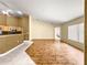 Open living room with hardwood floors, kitchen access, and great natural light, perfect for modern living and entertaining at 28 Golf View Dr, Ocala, FL 34472