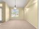 Light-filled room with neutral carpet, large window, and simple design at 28 Golf View Dr, Ocala, FL 34472