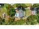Aerial view of the property showcasing a large lot, pool, RV parking, and fenced-in yard surrounded by mature trees at 2820 Se 14Th St, Ocala, FL 34471