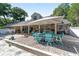 Expansive backyard with a brick patio, pool, and mature trees perfect for outdoor entertaining and relaxation at 2820 Se 14Th St, Ocala, FL 34471