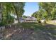 Large backyard with a patio, pool, and plenty of seating for entertaining, all surrounded by mature trees and a fence at 2820 Se 14Th St, Ocala, FL 34471