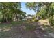 Expansive backyard featuring mature trees, pool, patio, and camper, perfect for outdoor living and relaxation at 2820 Se 14Th St, Ocala, FL 34471