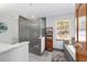 Modern bathroom featuring a glass shower, soaking tub, and sleek vanity at 2820 Se 14Th St, Ocala, FL 34471