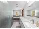 Elegant bathroom with glass shower, soaking tub, and double granite vanity at 2820 Se 14Th St, Ocala, FL 34471