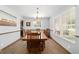 Charming dining room with wood floors, a rustic table, and window views at 2820 Se 14Th St, Ocala, FL 34471