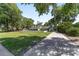 Brick home with a long driveway, white picket fence, mature trees, and expansive front lawn at 2820 Se 14Th St, Ocala, FL 34471
