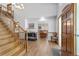 Inviting foyer with beautiful wood staircase, a warm color palette, and dining room view at 2820 Se 14Th St, Ocala, FL 34471