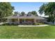 Inviting single-story brick home with a covered porch, dormer windows, and well-manicured lawn at 2820 Se 14Th St, Ocala, FL 34471