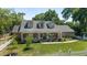 Beautiful brick home featuring a covered porch, dormer windows, an American flag, and a white picket fence at 2820 Se 14Th St, Ocala, FL 34471