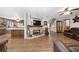Spacious open living space with a brick fireplace and view into kitchen with island at 2820 Se 14Th St, Ocala, FL 34471