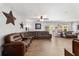 Spacious living room featuring a large brown leather sectional, stylish decor, and sliding glass doors at 2820 Se 14Th St, Ocala, FL 34471