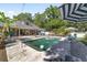 Enjoy the sparkling pool with its unique design, surrounded by lush greenery and comfortable seating areas at 2820 Se 14Th St, Ocala, FL 34471