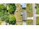 Birds eye view of a home showcasing a new metal roof and mature trees in a quiet residential neighborhood at 2981 Ne 39Th Pl, Ocala, FL 34479