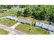 Aerial view of home with metal roof, nestled on a lush, green lot in a quiet neighborhood at 2981 Ne 39Th Pl, Ocala, FL 34479