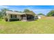 Spacious backyard featuring a well-maintained lawn and a screened-in porch at 2981 Ne 39Th Pl, Ocala, FL 34479