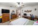 Bedroom with wood furnishings, desk, and access to the dining room and kitchen at 2981 Ne 39Th Pl, Ocala, FL 34479