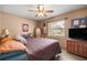 Comfortable bedroom with ceiling fan, window views, and ample natural light, creating a cozy atmosphere at 2981 Ne 39Th Pl, Ocala, FL 34479