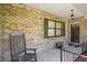 Charming front porch with brick detail, rocking chair, and inviting entryway at 2981 Ne 39Th Pl, Ocala, FL 34479