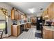 Spacious kitchen with wood cabinets, tile floors, and view into the dining area at 2981 Ne 39Th Pl, Ocala, FL 34479