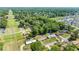Aerial view showcasing a serene residential neighborhood with mature trees and well-spaced homes at 2981 Ne 39Th Pl, Ocala, FL 34479