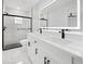 Modern bathroom with double sink vanity, illuminated mirror, and sleek glass-enclosed shower at 3079 Sw 168 Pl, Ocala, FL 34473