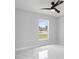 Bright bedroom features a large window with a view and modern ceiling fan at 3079 Sw 168 Pl, Ocala, FL 34473