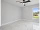 Bright bedroom featuring a ceiling fan, luxury vinyl floors, and a large window at 3079 Sw 168 Pl, Ocala, FL 34473