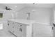 Open floorplan featuring a large white kitchen island with marble floors and modern lighting at 3079 Sw 168 Pl, Ocala, FL 34473