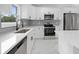 A modern kitchen with stainless steel appliances and white cabinets at 3079 Sw 168 Pl, Ocala, FL 34473