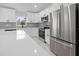 A well lit kitchen features new stainless appliances, white cabinets and marble floors at 3079 Sw 168 Pl, Ocala, FL 34473