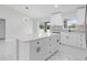 Open concept kitchen features a modern light fixture, an island, and stainless steel appliances at 3079 Sw 168 Pl, Ocala, FL 34473