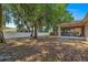 Spacious backyard featuring mature trees, a white fence, and a view of the screened-in lanai at 3102 Ne 26Th St, Ocala, FL 34470