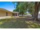 View of the home's generous, well-maintained backyard with mature trees and white fencing for privacy at 3102 Ne 26Th St, Ocala, FL 34470