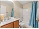 Clean bathroom featuring a tiled shower-tub combo, vanity, and a well-lit mirror at 3102 Ne 26Th St, Ocala, FL 34470