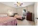 Comfortable bedroom featuring two beds, a ceiling fan, and natural light at 3102 Ne 26Th St, Ocala, FL 34470