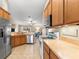 Functional kitchen with wooden cabinets, stainless steel appliances, and an open view to the living area at 3102 Ne 26Th St, Ocala, FL 34470