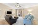 Cozy living room with comfortable seating, sliding glass doors, and ample natural light creating a relaxing atmosphere at 3102 Ne 26Th St, Ocala, FL 34470