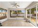 Enclosed tile patio featuring a ceiling fan with views of the spacious backyard, perfect for relaxing at 3102 Ne 26Th St, Ocala, FL 34470