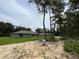 A new home's backyard features a grassy lawn, ready for outdoor enjoyment in a peaceful, wooded setting at 4105 Se 138Th Pl, Summerfield, FL 34491