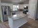 Modern kitchen with stainless steel appliances, a center island, and granite countertops at 4105 Se 138Th Pl, Summerfield, FL 34491