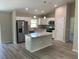 Open-concept kitchen featuring stainless steel appliances, a center island, and modern finishes at 4105 Se 138Th Pl, Summerfield, FL 34491