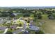 Aerial view of a residential neighborhood with manicured lawns, tree coverage and a pond at 4360 Sw 62Nd Loop, Ocala, FL 34474