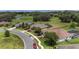 Aerial view of a neighborhood with well-maintained lawns, landscaping, and pond at 4360 Sw 62Nd Loop, Ocala, FL 34474