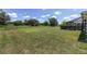 A spacious backyard features a neatly trimmed lawn, mature trees, and a fenced perimeter for added privacy at 4360 Sw 62Nd Loop, Ocala, FL 34474